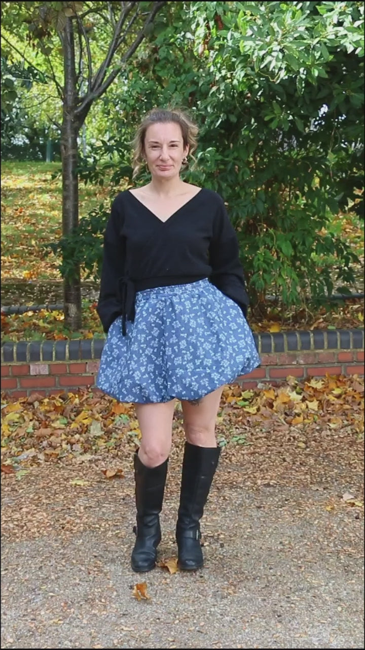 Ellie & Mac Sadie Bubble Skirt sewing pattern with a model wearing a blue mini skirt made from cotton fabric. Includes a projector file, A0 copy shop file, letter and A4 print file, and PDF color photo step-by-step instructions. Easy for beginner sewists. Quick sewing project. 