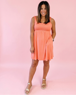 Suzie empire waist square neck knit dress sewing pattern with flowy skirt Ellie and Mac. Pockets make this dress perfect for everyday wear.