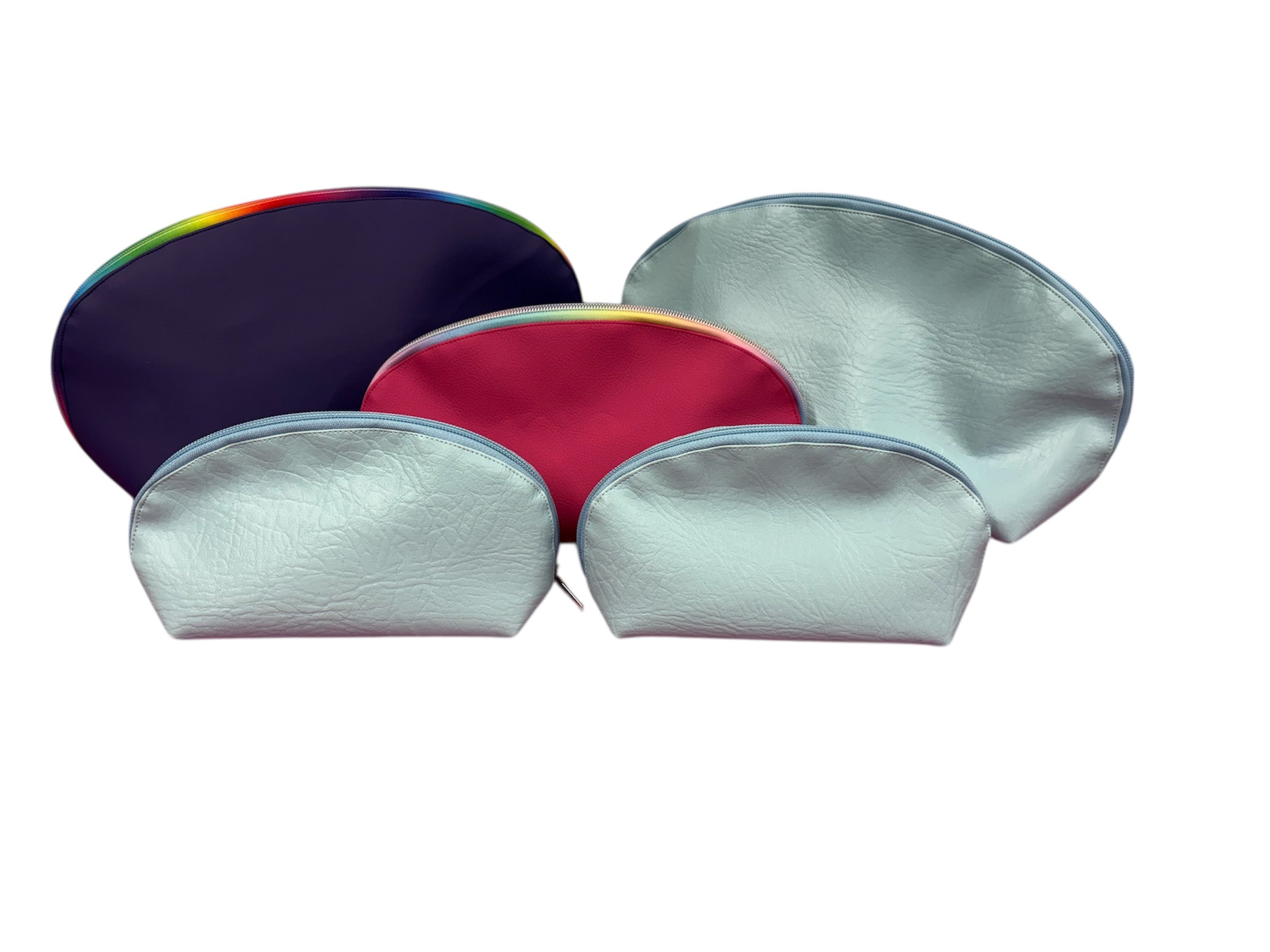 Three sizes of the Tessa Toiletry Pouch sewing pattern displayed together to show scale options.