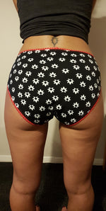 Woman wearing a black bikini brief panty with white floral fabric and red picot elastic details. Fast sewing project. Includes sizes xxs - 5xl. low-rise, mid-rise, and high-rise options. Instant download.