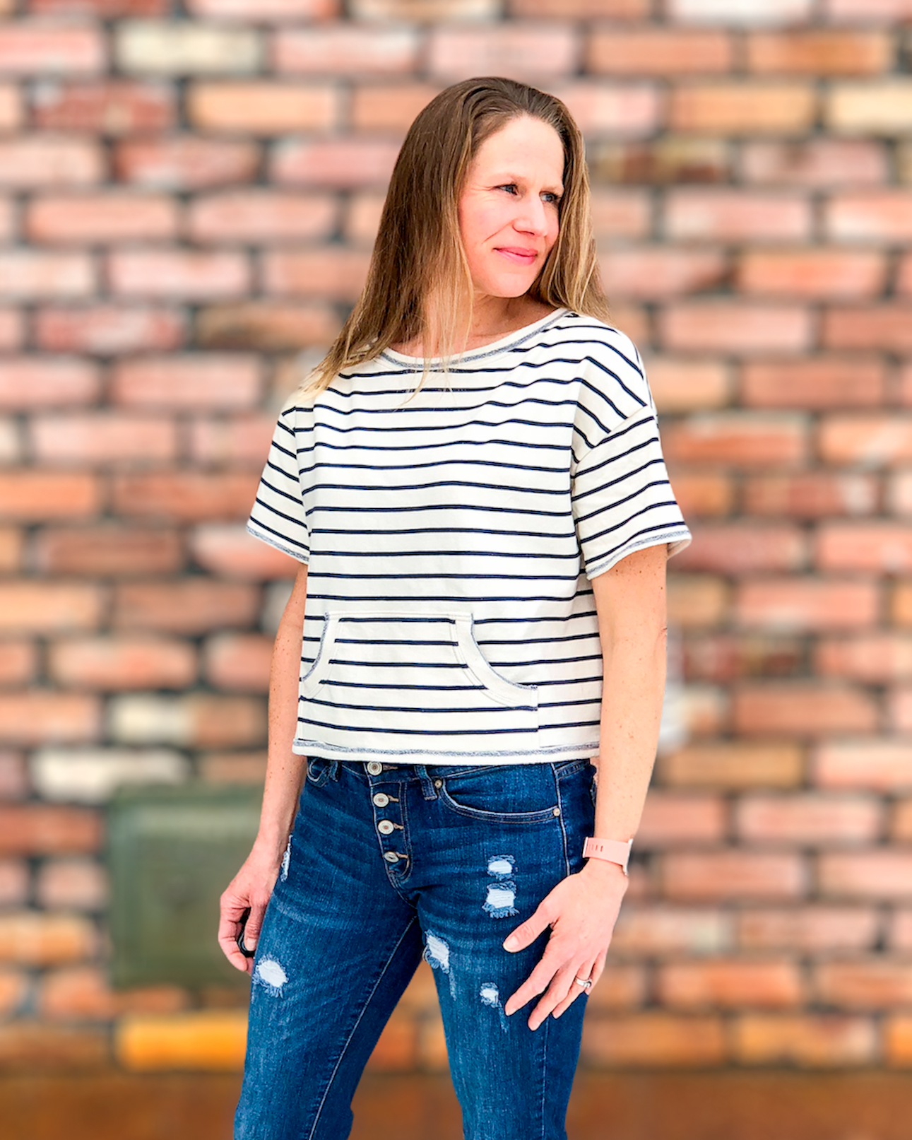 Woman wearing a short sleeve cropped striped tee 