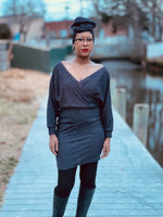 Woman wearing a glittery faux wrap dress for a date night. This sewing pattern featuring dolman sleeves and batwing style bodice