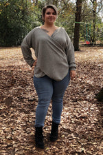 Woman wearing a grey ribbed dolman sleeve wrap sweater and jeans. Sweater was made using the Ellie and Mac pattern for knit fabrics.