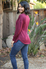 Ellie and Mac sewing patterns for beginners. Model wearing a burgundy crossover dolman sweater.