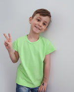 Boy in lime green oversized short sleeve t-shirt sewn using the oversized tee pattern by Ellie and Mac