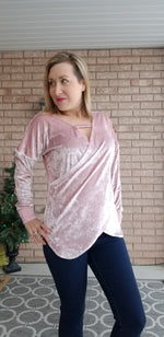 Women wearing a light pink velvet Faux wrap sweater sewing pattern with batwing sleeves and crossover bodice.