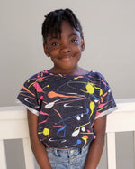 Girl wearing a paint splash print oversized cropped t-shirt made using Ellie and Mac sewing patterns.