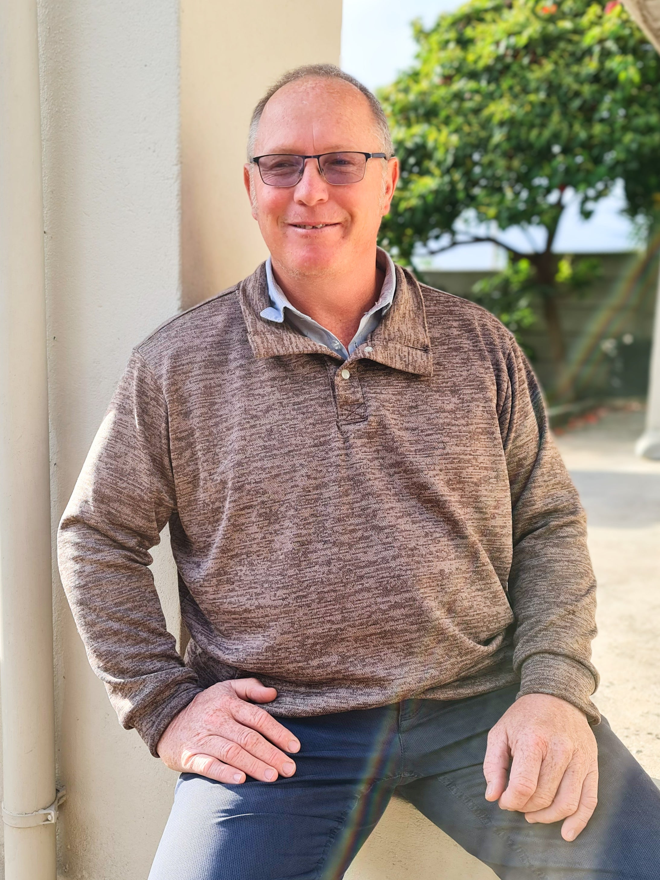 Man wearing a half button front pullover sweater. 