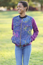 Girl wearing a cosmic print bomber jacket with knit long sleeves and zip front. 