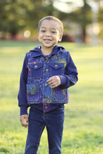 Boy wearing a cosmic print bomber jacket in purples and navy. Long sleeve with a hood. Woven and knit fabrics. Easy sewing pattern. 