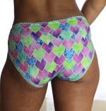 Woman modeling a mid-rise pair of underwear briefs with picot elastic details. The panties are sexy and comfortable at the same time. Great for using up fabric scraps, upcycling old clothing, and making underwear that fit you perfectly.