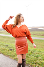 Model wearing handmade crossover wrap dress in solid fabric