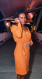 Woman wearing a Modern crossover  orange sweater dress made from a pdf pattern for confident beginner sewists
