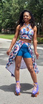 Woman modeling a open front skort with colorful knit fabric and blue shorts. Cut high-low hemline sewing pattern. Comfort and style with this easy sewing pattern for knit fabrics. 