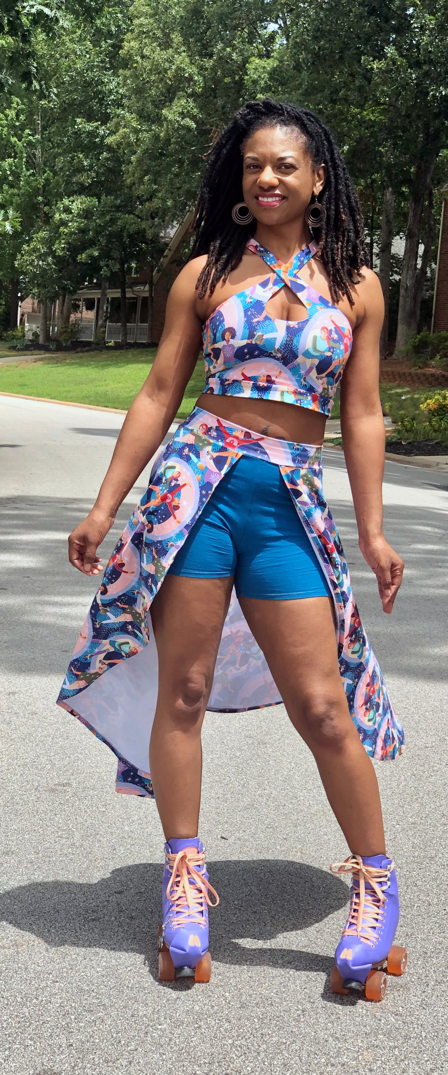 Woman modeling a open front skort with colorful knit fabric and blue shorts. Cut high-low hemline sewing pattern. Comfort and style with this easy sewing pattern for knit fabrics. 