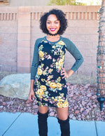 Women wearing a floral sweater dress with striped raglan sleeves and thigh high boots.