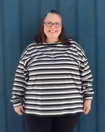Woman wearing an oversized striped sweater she made using Ellie and Mac patterns.